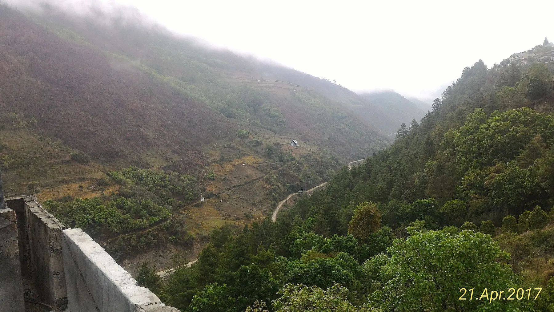 Road winding through misty hills of Arunachal Pradesh