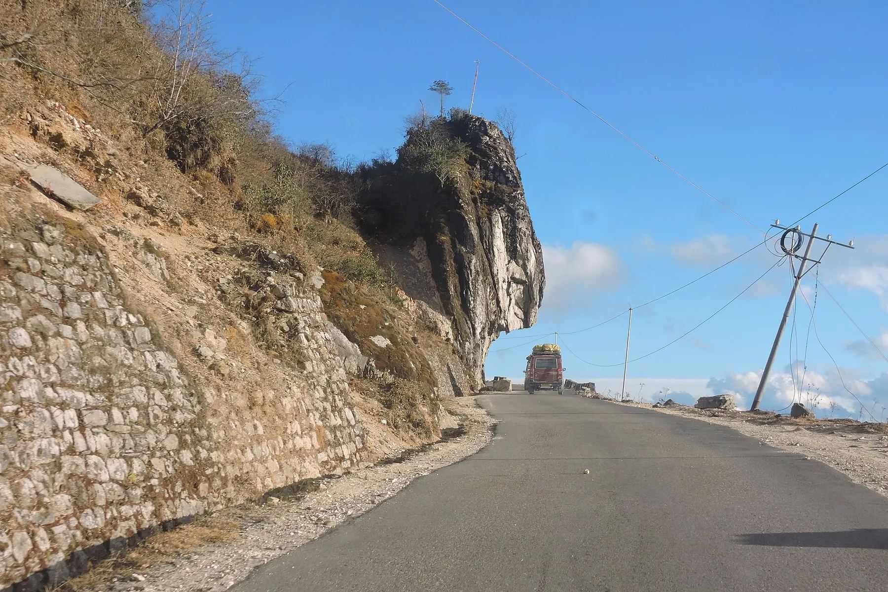 Mountain road cut into the cliffs approaching Sela Pass