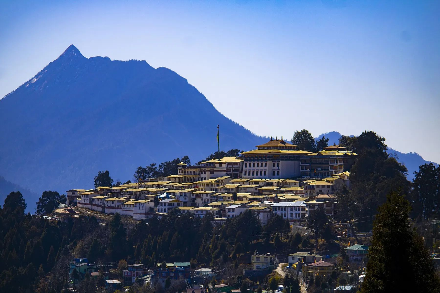 Tawang Monastery on its ridge beneath a Himalayan peak