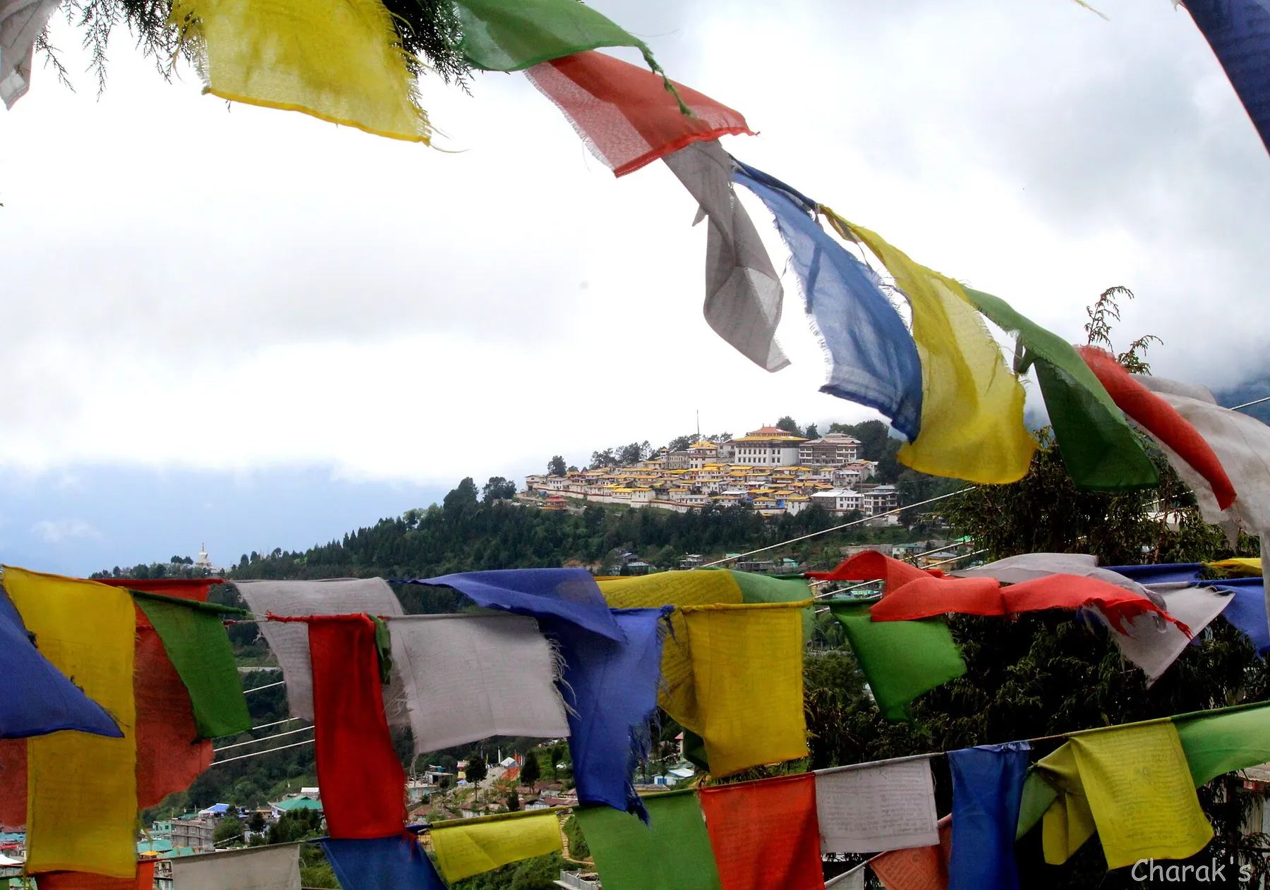 Prayer flags with Tawang Monastery in the distance